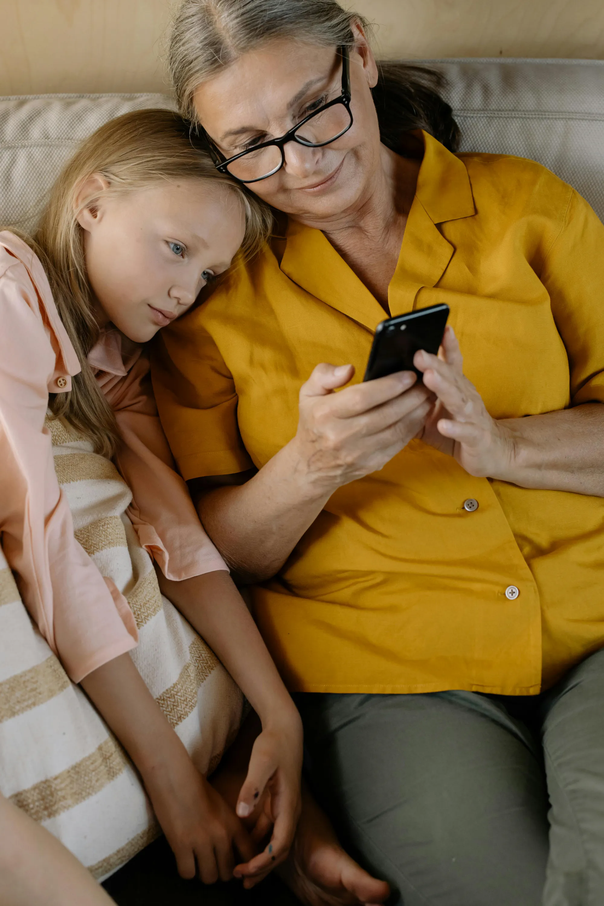 A grandmother and granddaughter looking at photos together