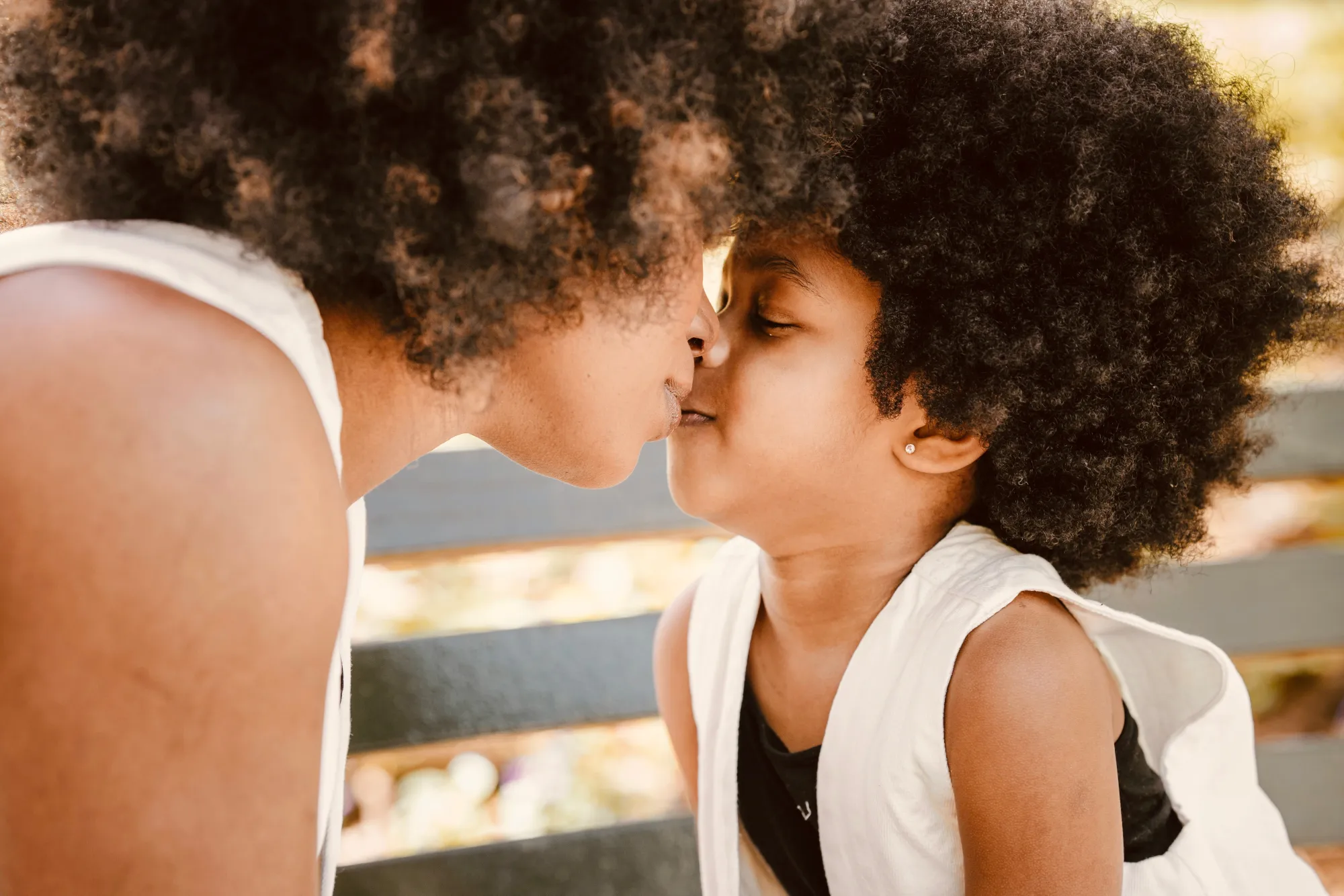 Mother and child touching noses, foreheads together